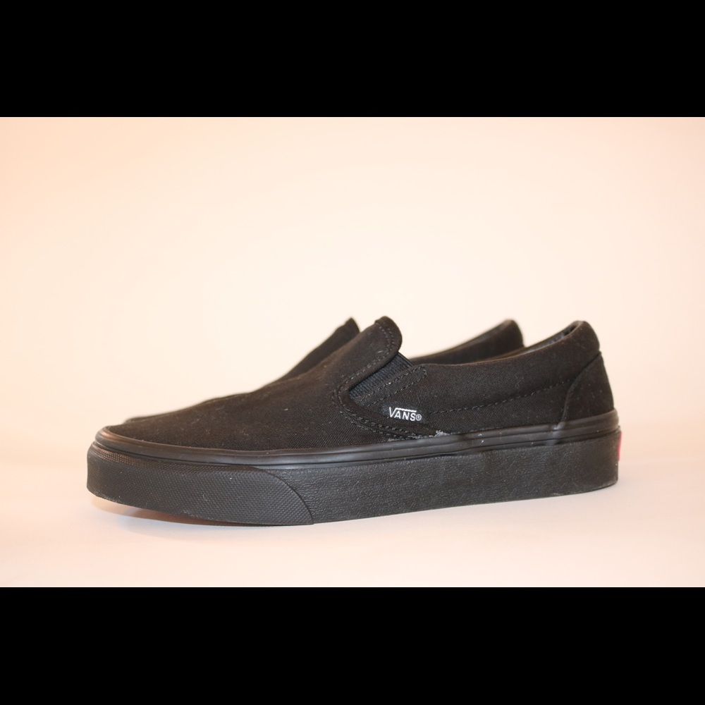 All black slip on vans